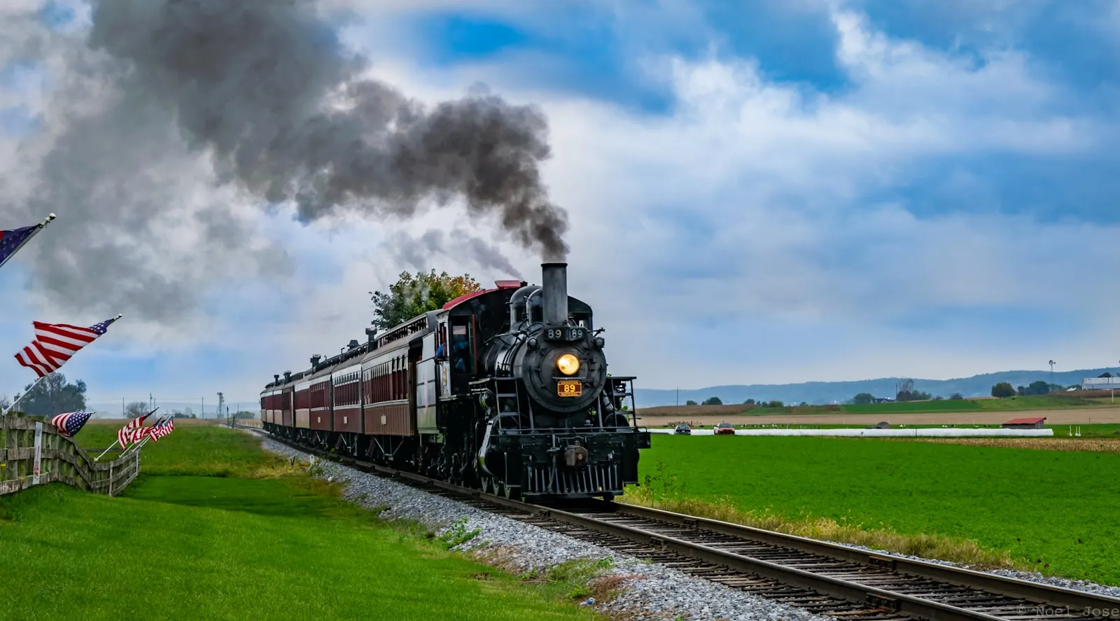 Black and red passenger train on tracks under blue sky — the Amtrak intercity locomotive context
