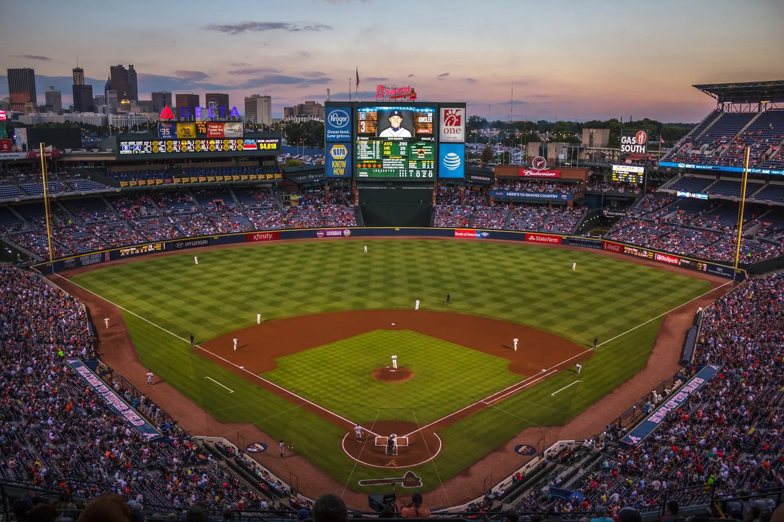 Players and fans on a baseball field — Truist Park where the Braves' train-themed audio cue plays