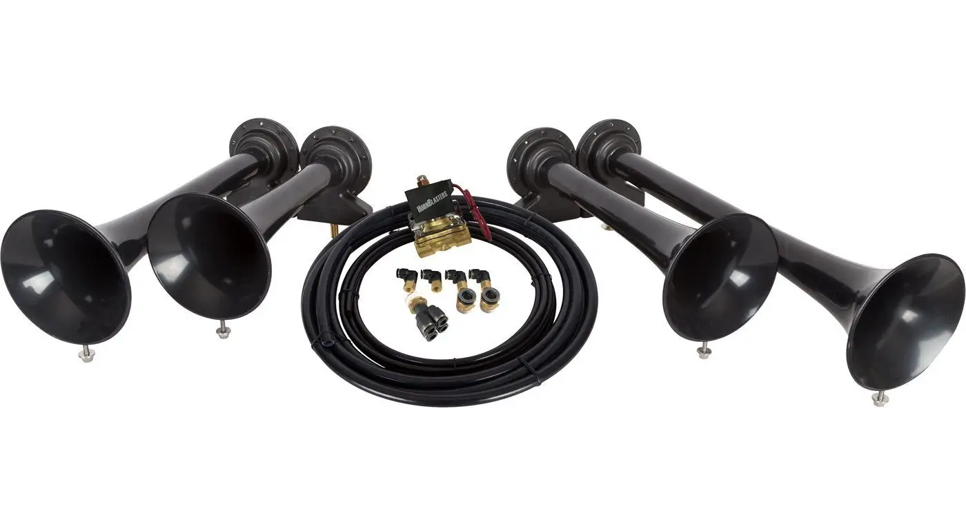 Four-trumpet aftermarket train horn kit laid out with solenoid valve, air line, and fittings, the components to inspect on a used kit