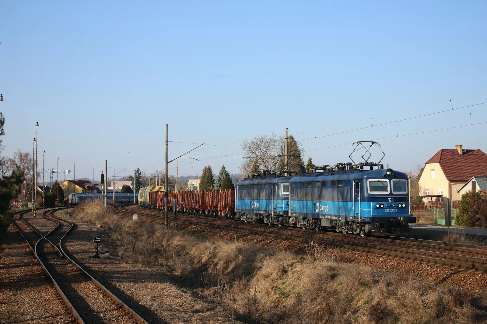 Blue electric / diesel-electric locomotive pulling freight — modern diesel-power horn context