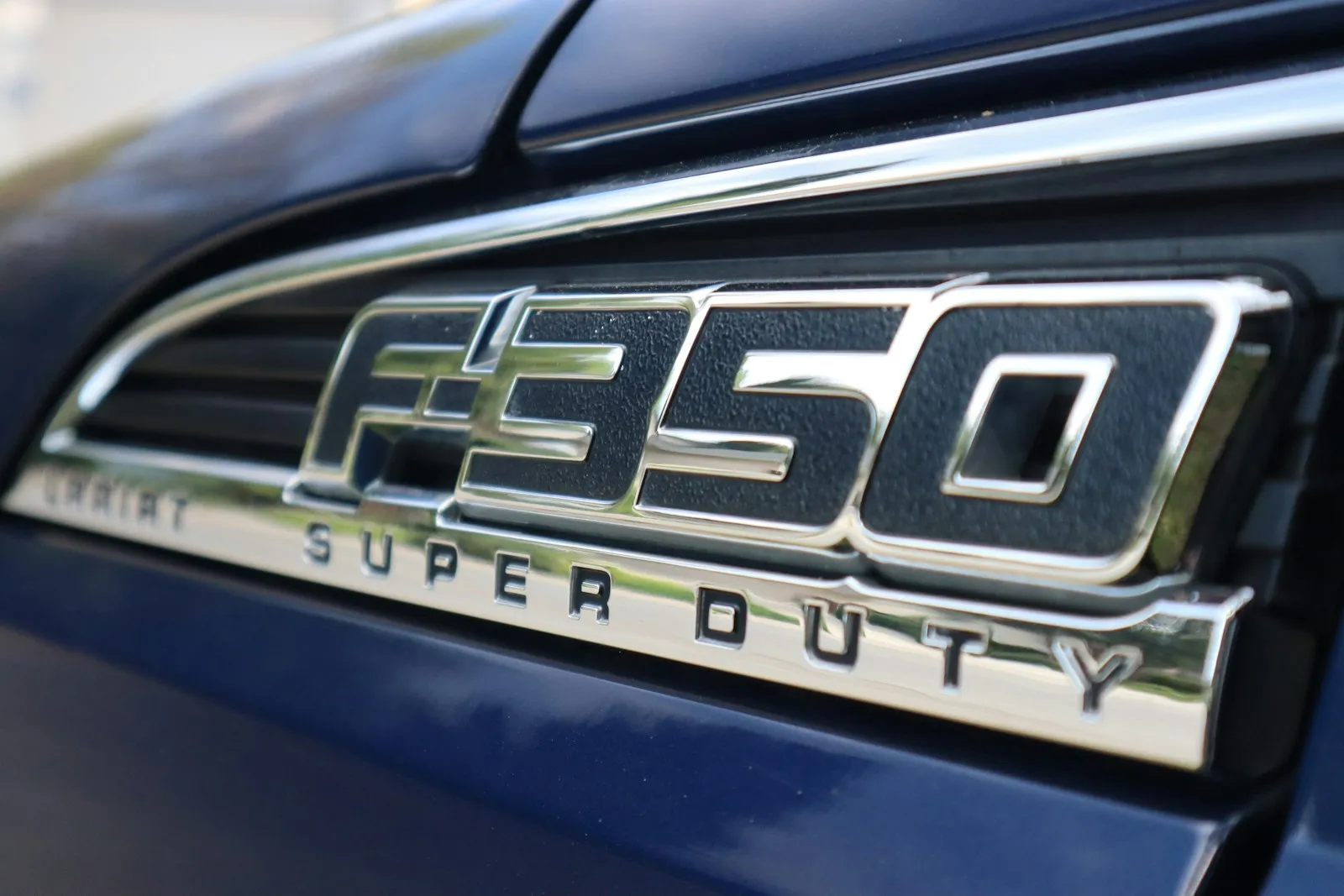 Blue Ford F-350 emblem close-up — Super Duty F-250 install context