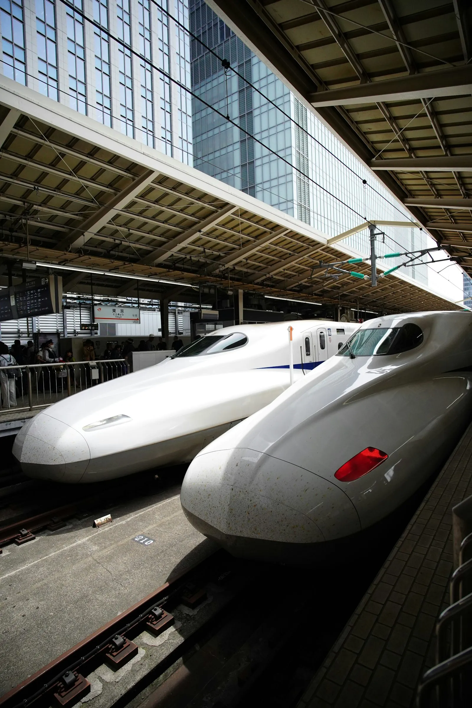 Two sleek Japanese bullet trains at a station — the UIC two-tone horn voice of JR rail