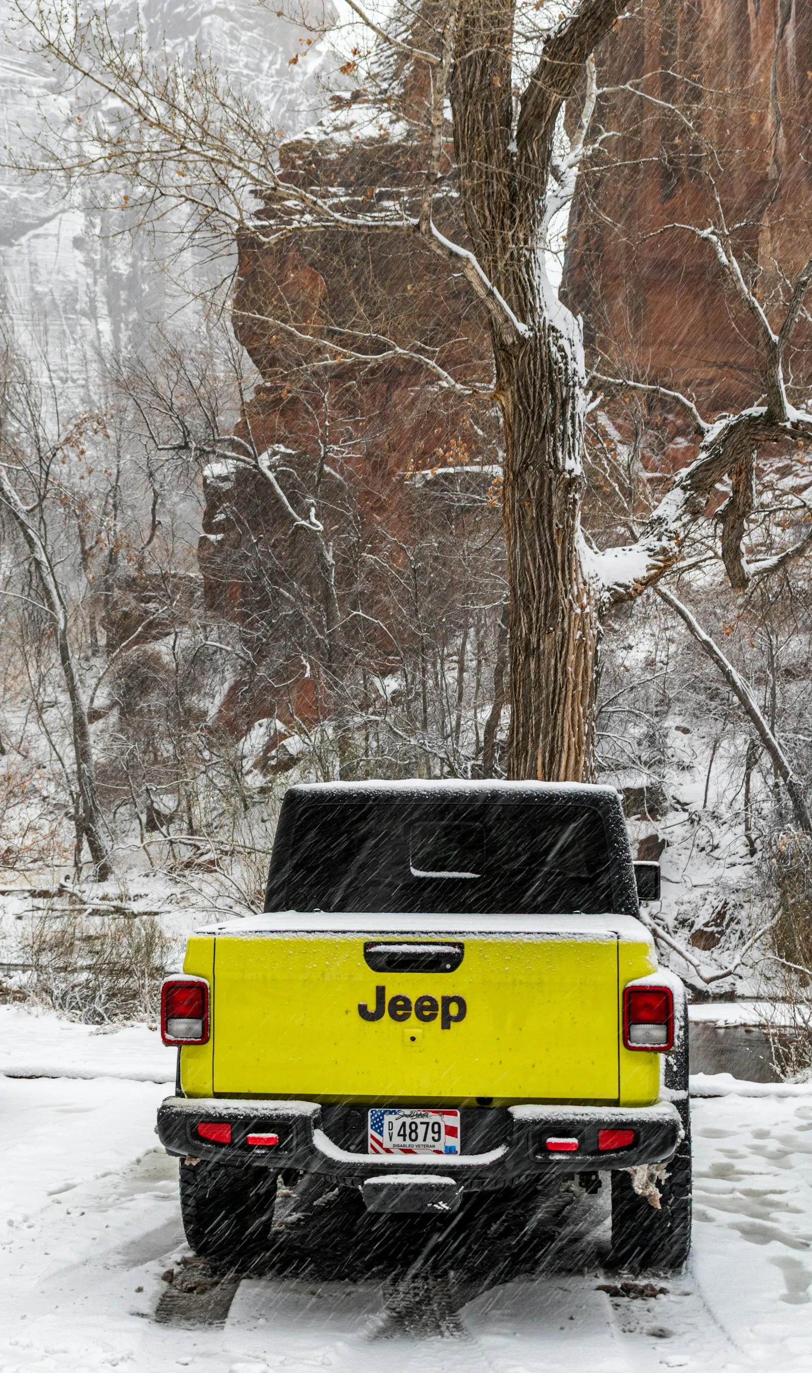 Yellow Jeep Gladiator pickup in snowy landscape — Gladiator install context