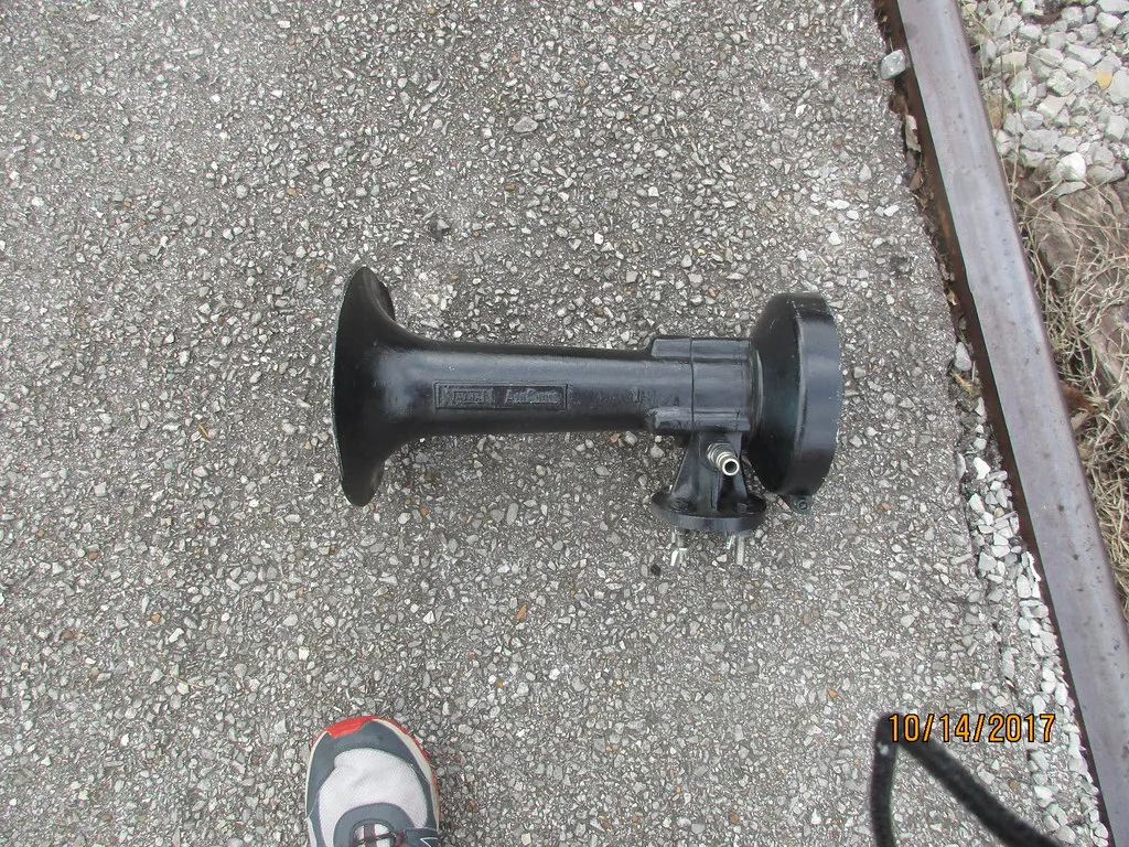 Chrome air-powered train horn mounted on display
