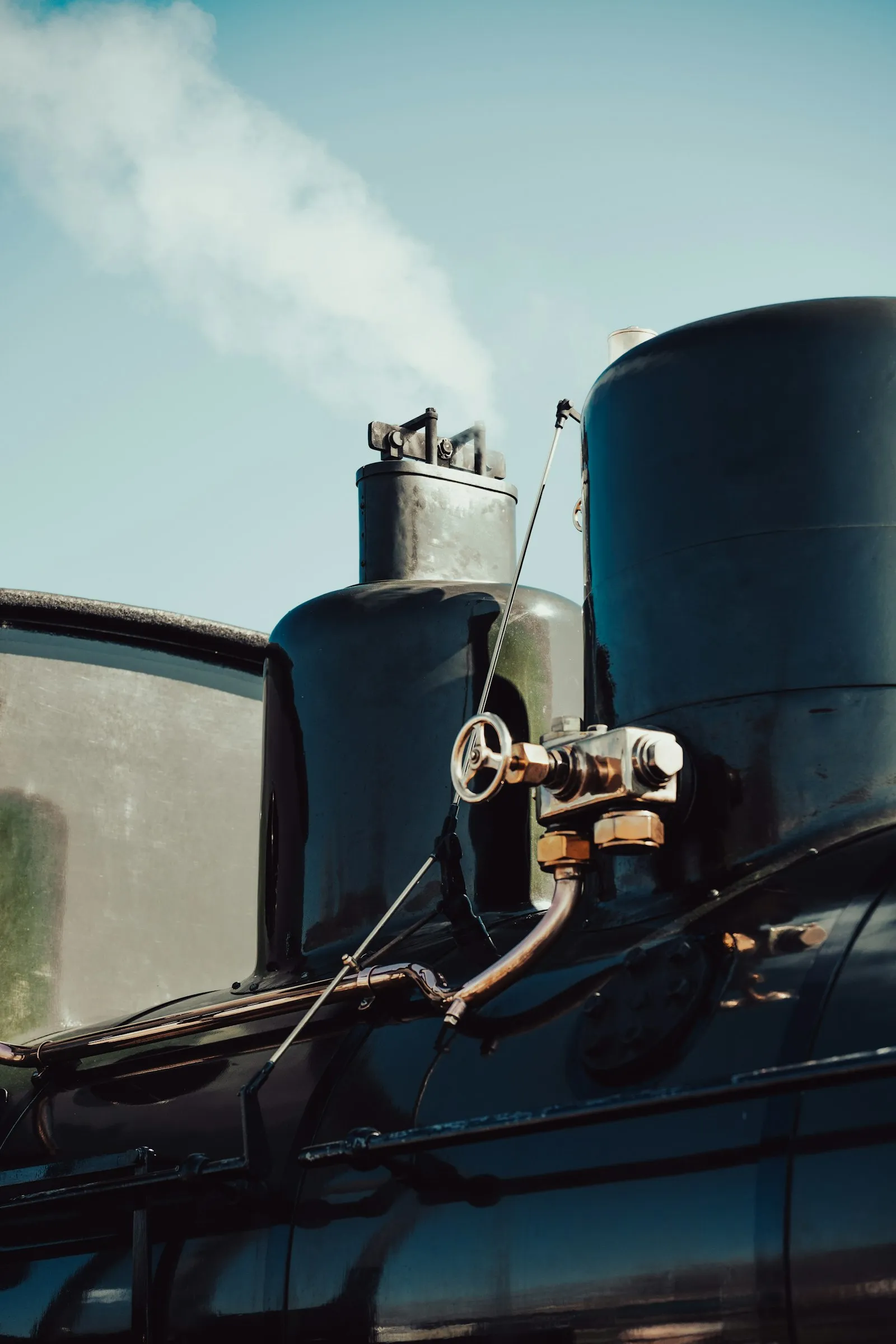 Steam billowing from a vintage locomotive — Wolo's heritage-tier compact horn channels that classic-rail aesthetic