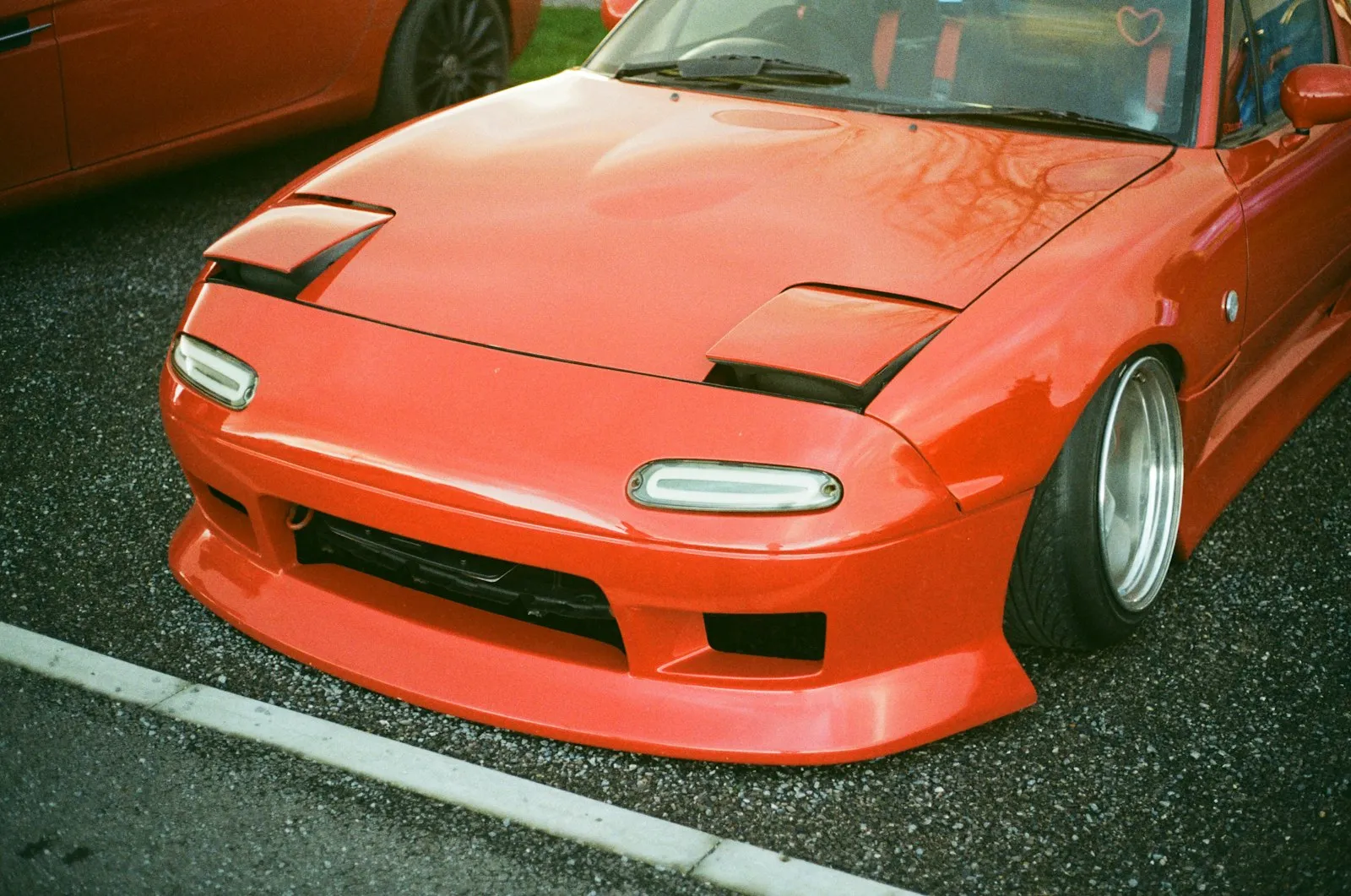 Red Mazda Miata sports car — Miata roadster install context