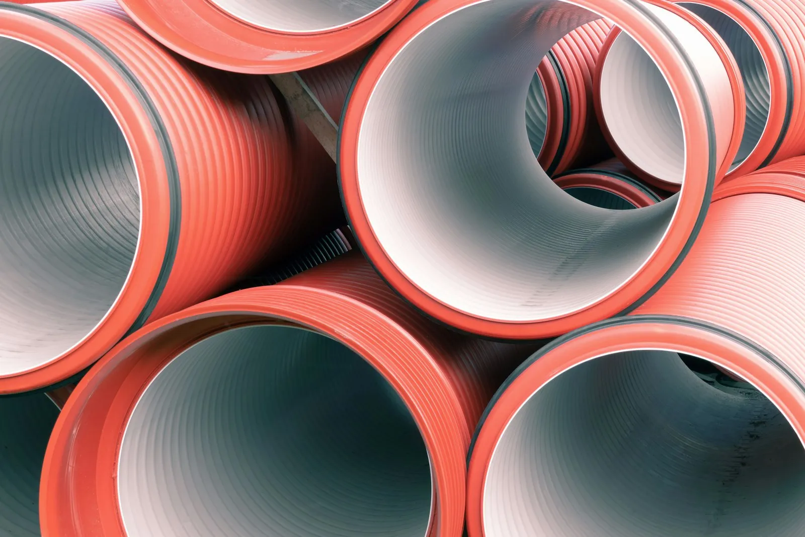 Stacked red and white pipes — PVC sections that get cut to bell length per the K5LA chord plans