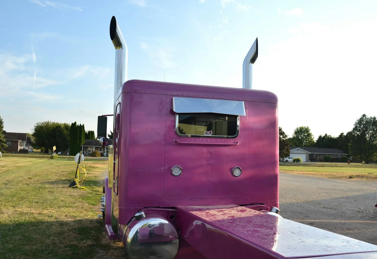 Pink semi-truck with chrome exhaust pipes — the Class 8 / heavy-duty install context for the Rhino + 544 kit