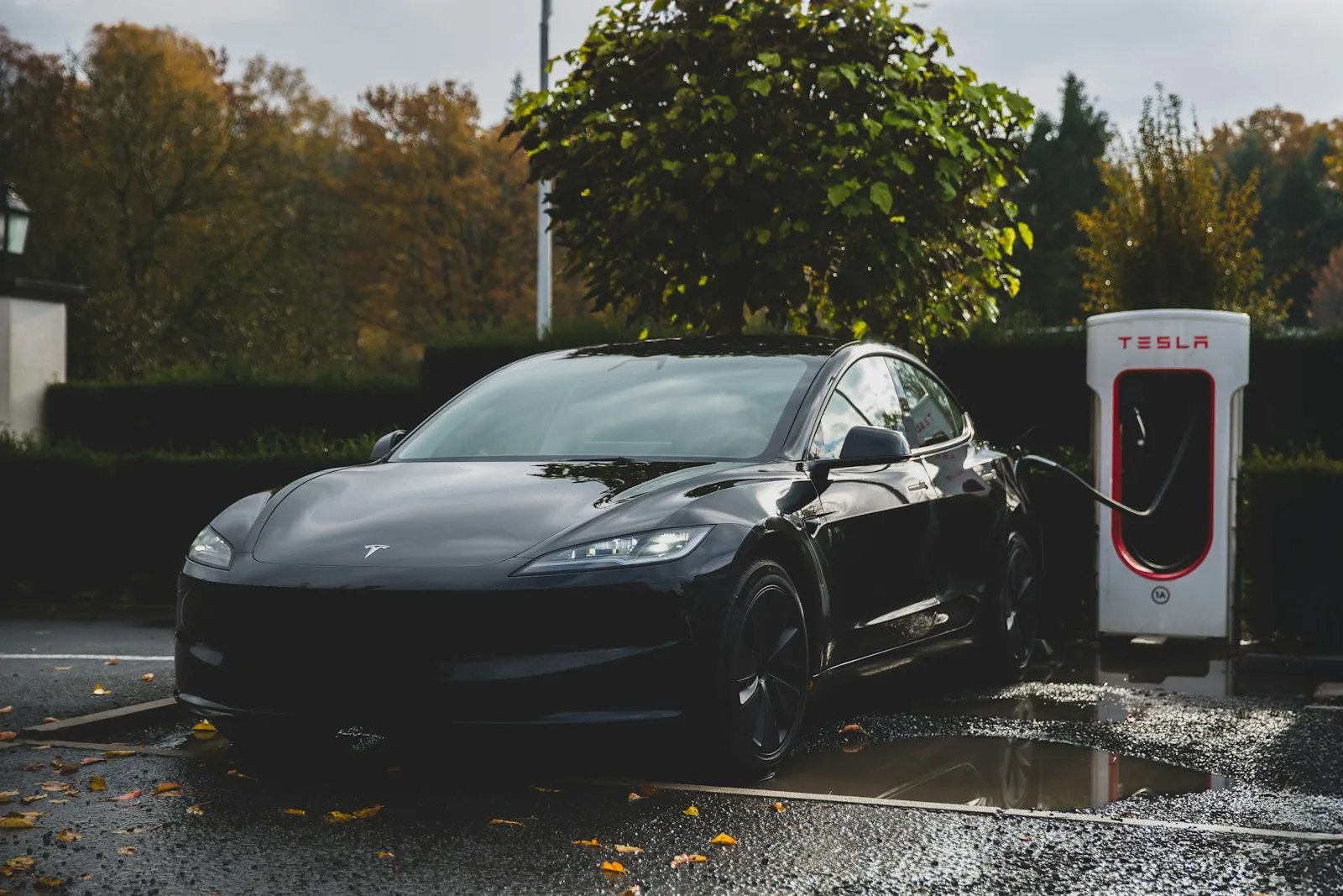 Tesla electric car charging at a charging station — Tesla install context