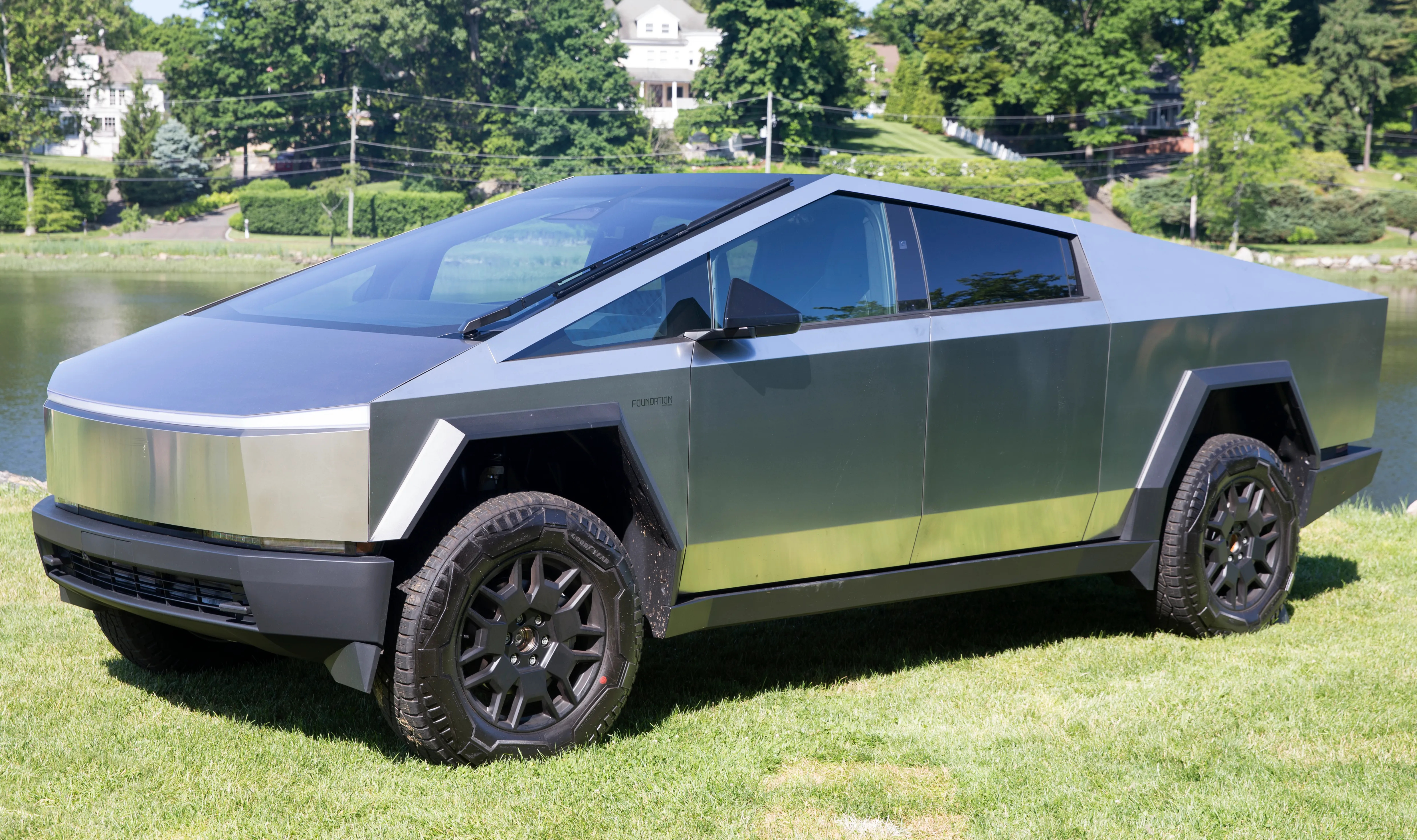 2024 Tesla Cybertruck Foundation Series parked, front left view, showing the stainless steel body and frunk area used for train horn installs