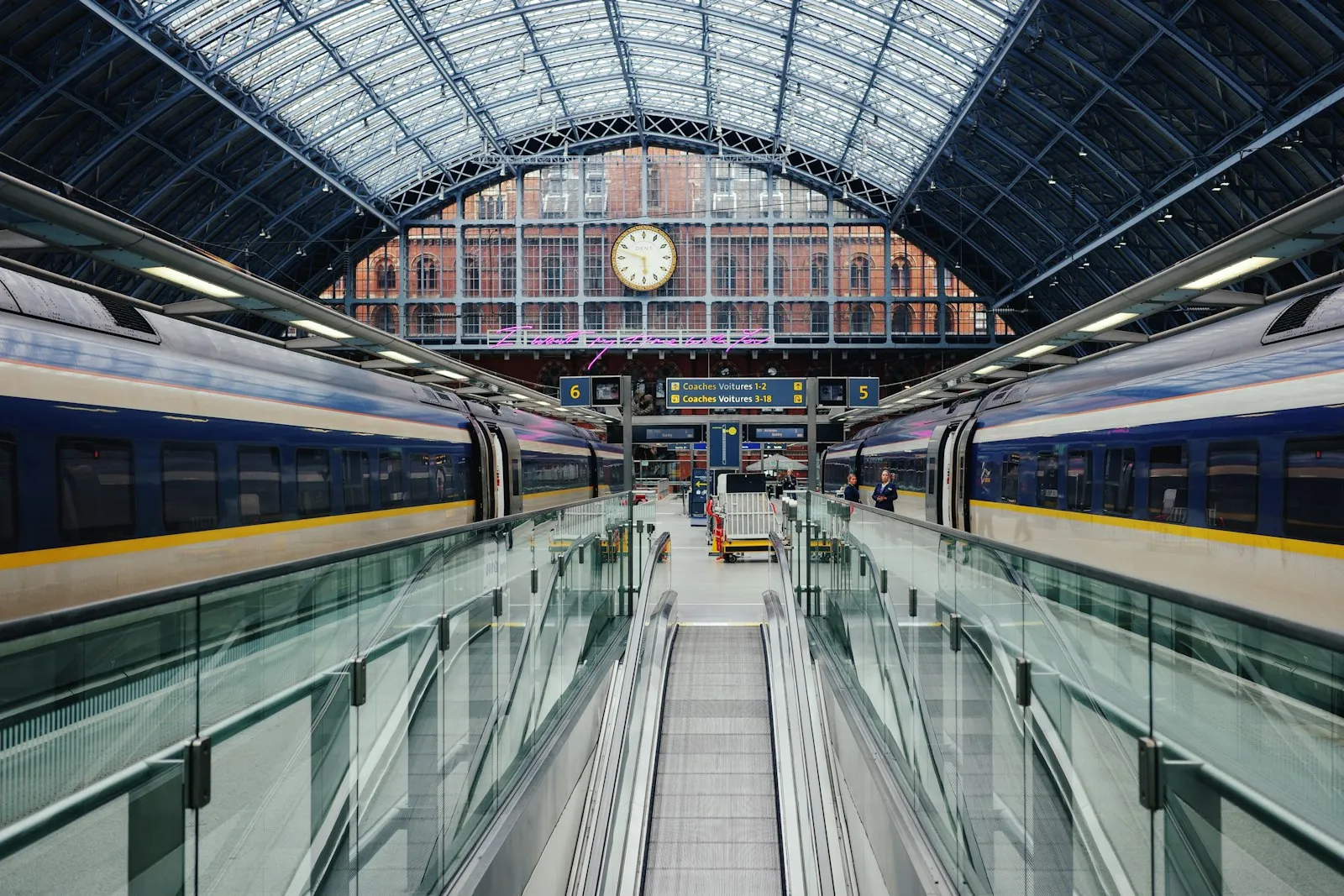 UK train at a station with a clock — Network Rail Class 800 / UIC 370/660 Hz two-tone context