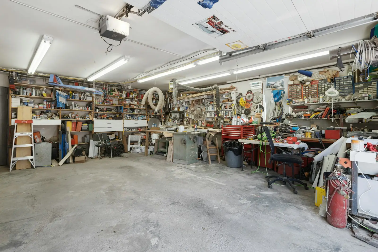 A garage filled with lots of clutter and tools