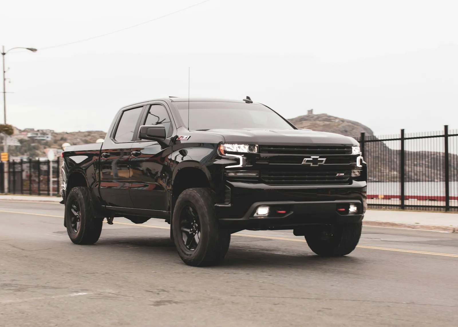Black Chevy single cab pickup — compact-budget install context where Wolo's Long Island OEM-heritage kits compete