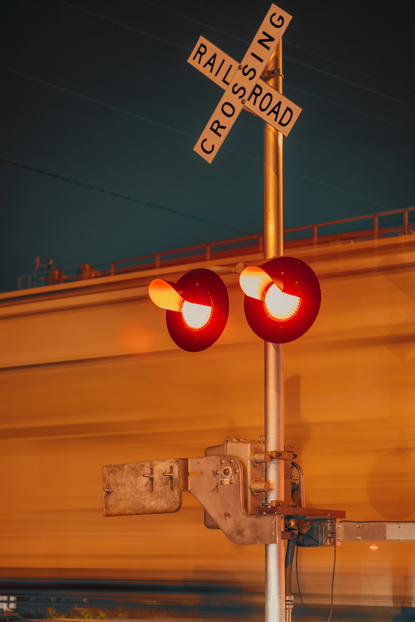 Railroad crossing signal at night — the kind of switcher / yard environment where the K3LA chord still appears