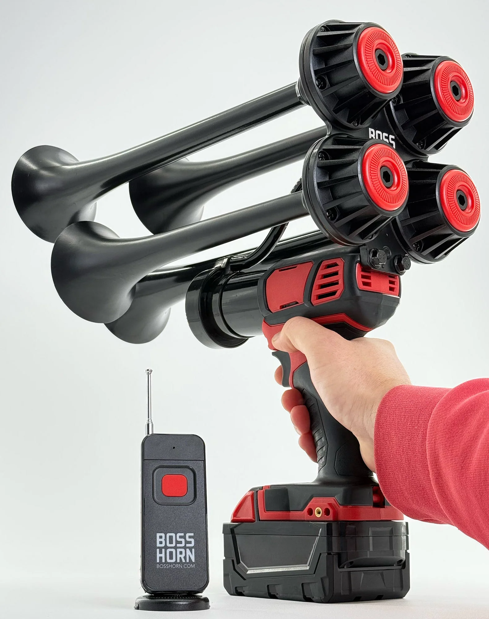 Boss Series held by its trigger grip, with wireless remote and M18-compatible battery pack